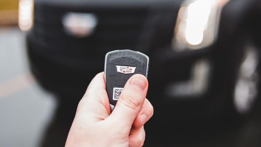 Person holding a car key by an SUV