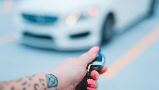Person unlocking a car with a key fob